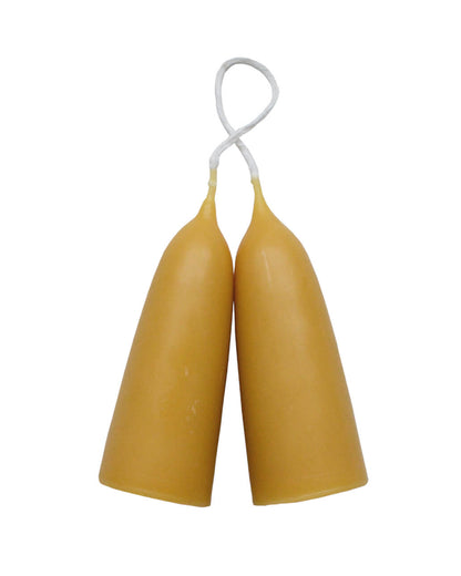 A pair of a stubby beeswax candles, on a white background.