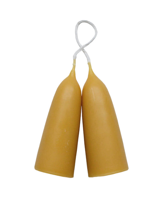 A pair of a stubby beeswax candles, on a white background.