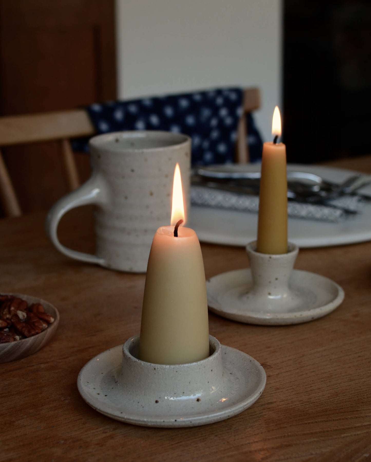 Beeswax candles on top of a dining table.