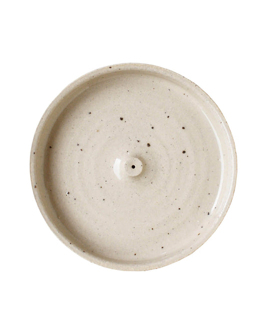 An oatmeal coloured ceramic hand-thrown incense holder.