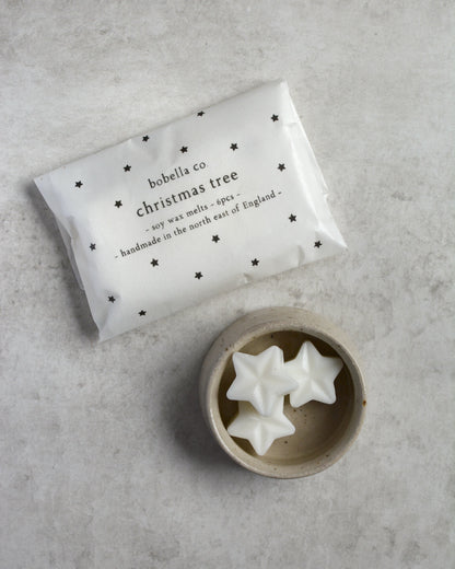 Star-shaped scented wax melts, next to a starry package of melts.