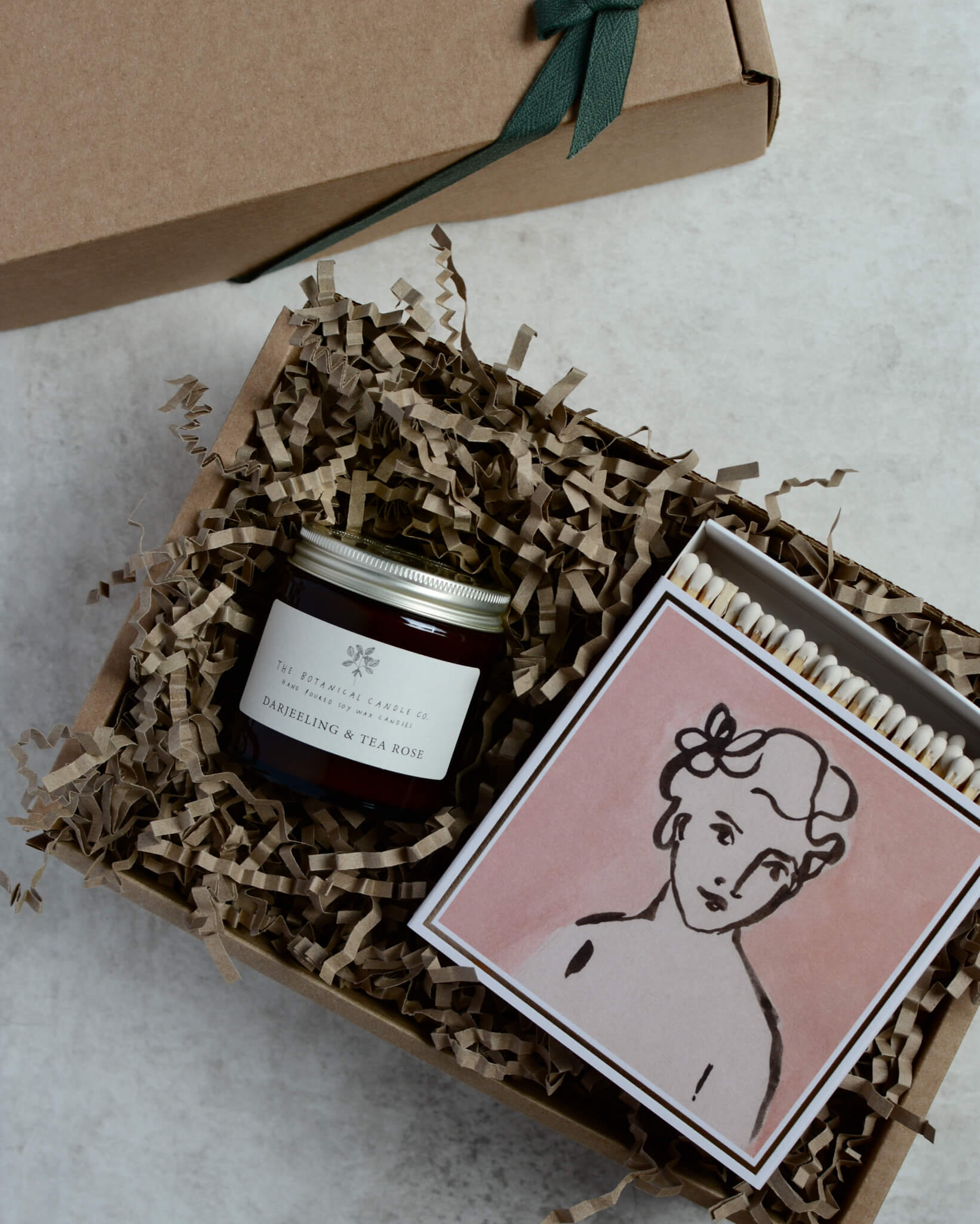 Darjeeling and Tea Rose scented soy candle by The Botanical Candle Co with a box of matches in a gift box.