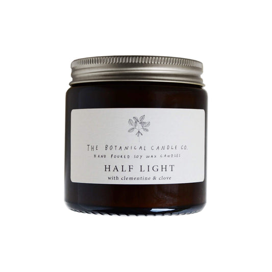 Half Light Scented Soy Candle in amber jar.