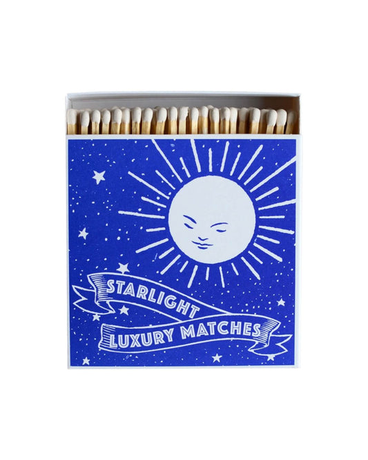 A blue box of matches, featuring a moon illustration.