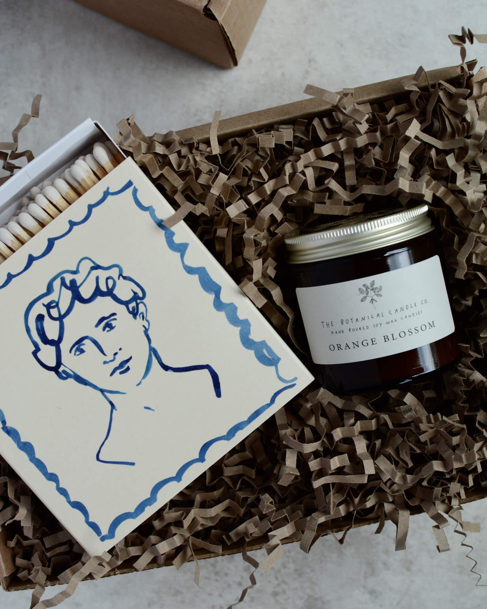 Orange Blossom scented soy wax candle by The Botanical Candle Co. in a gift box with matches.