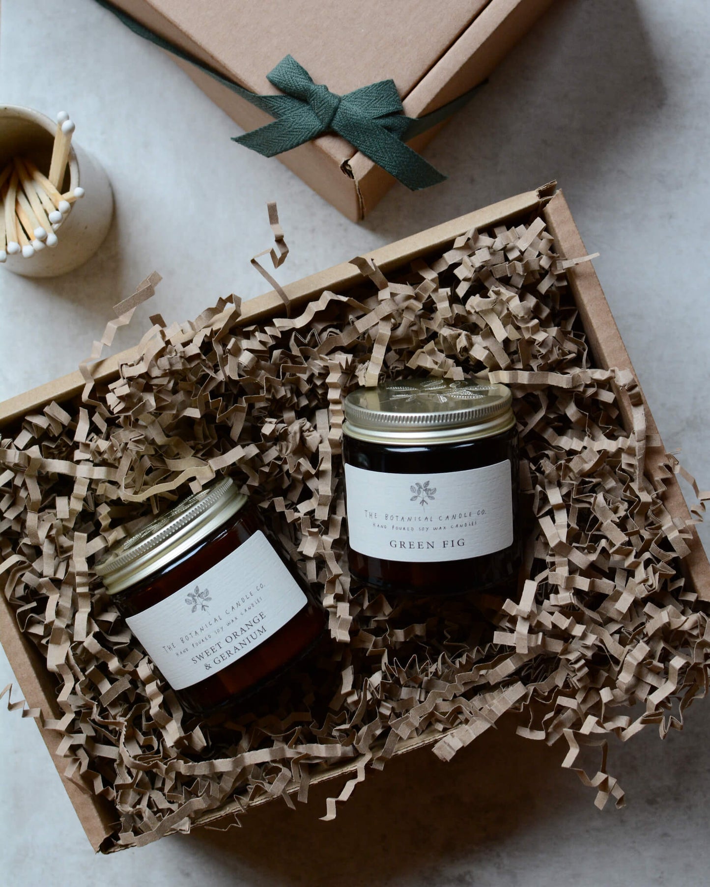 Pair of scented candles within a gift box.