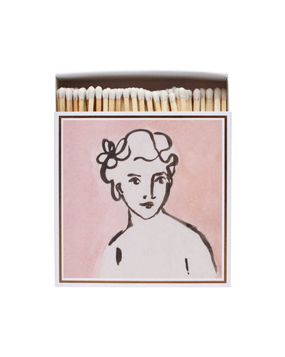 Pink matchbox featuring an illustrated portrait of a woman.