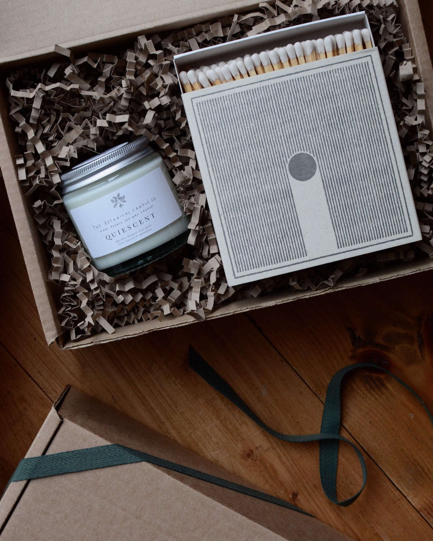 Quiescent scented candle and matches in a gift box.