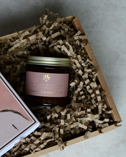 Rose and clementine scented candle with a pink label, in a gift box.