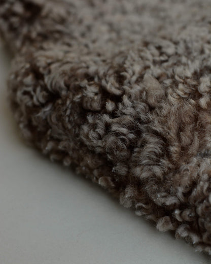 Close-up of a brown sheepskin hot water bottle.