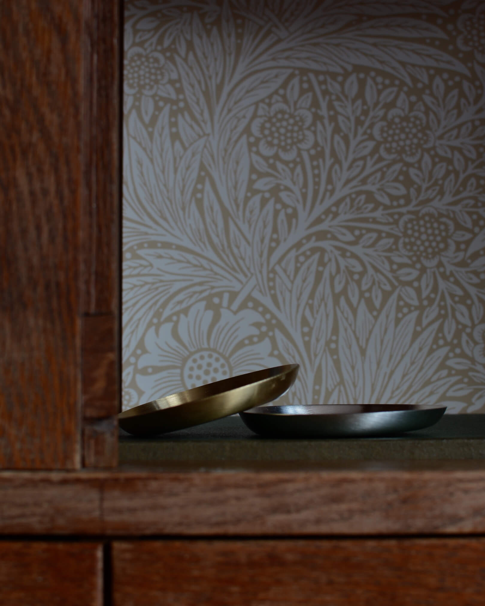 A solid brass candle dish, and a silver candle dish.