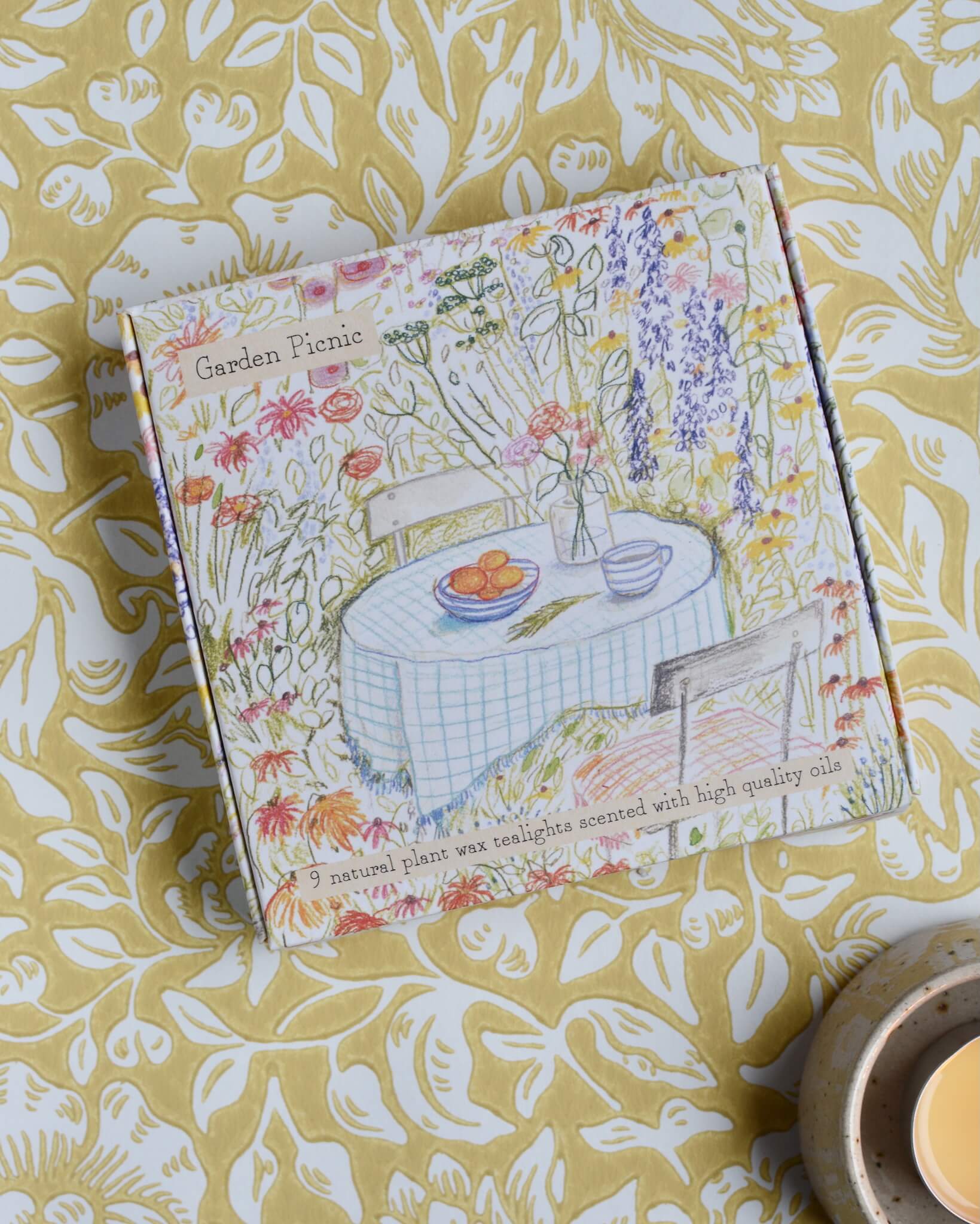 Garden Picnic scented tealights with a hand-illustrated box design, depicting a summer garden.