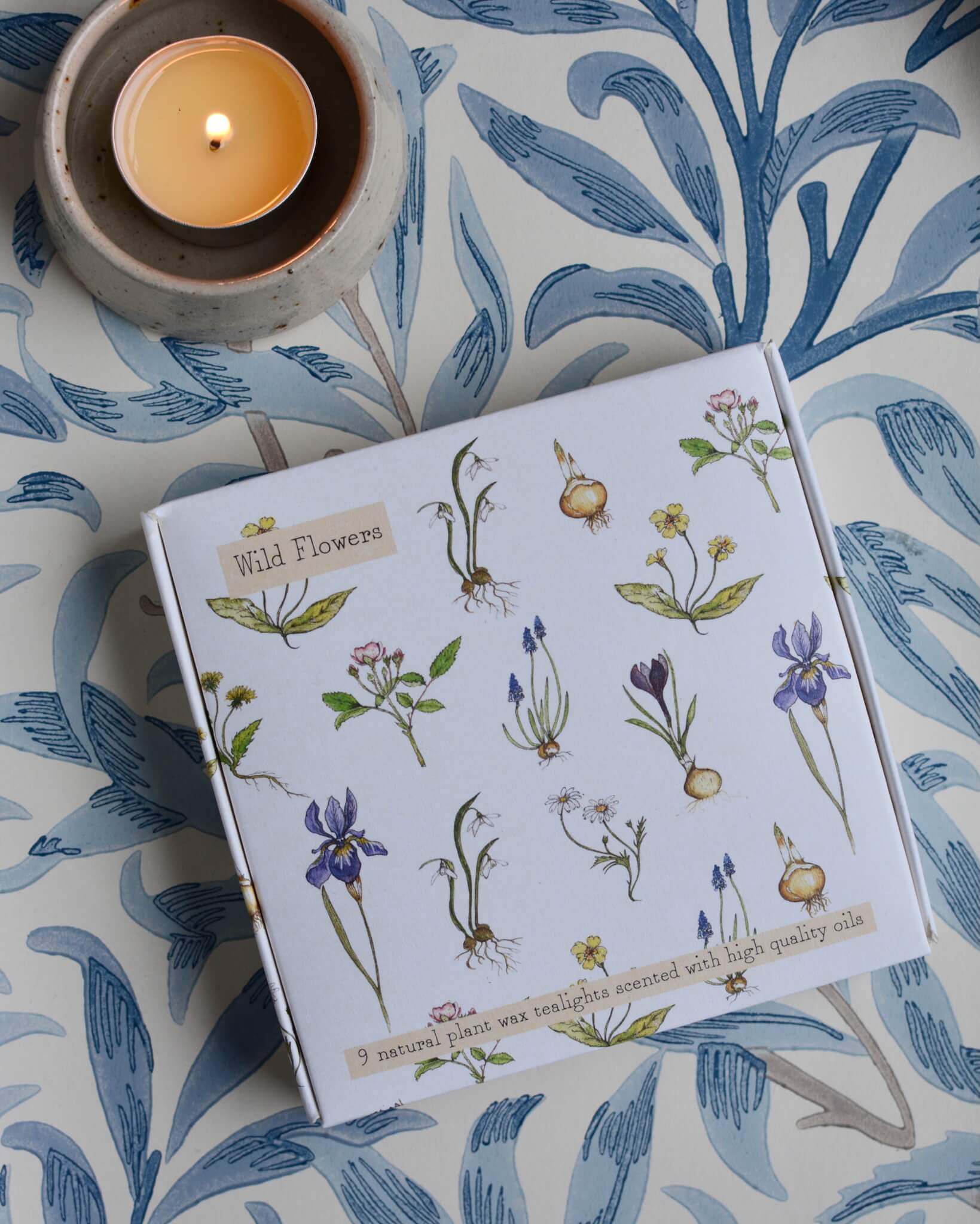 A box of tealights with an illustration of wild flowers on the box.