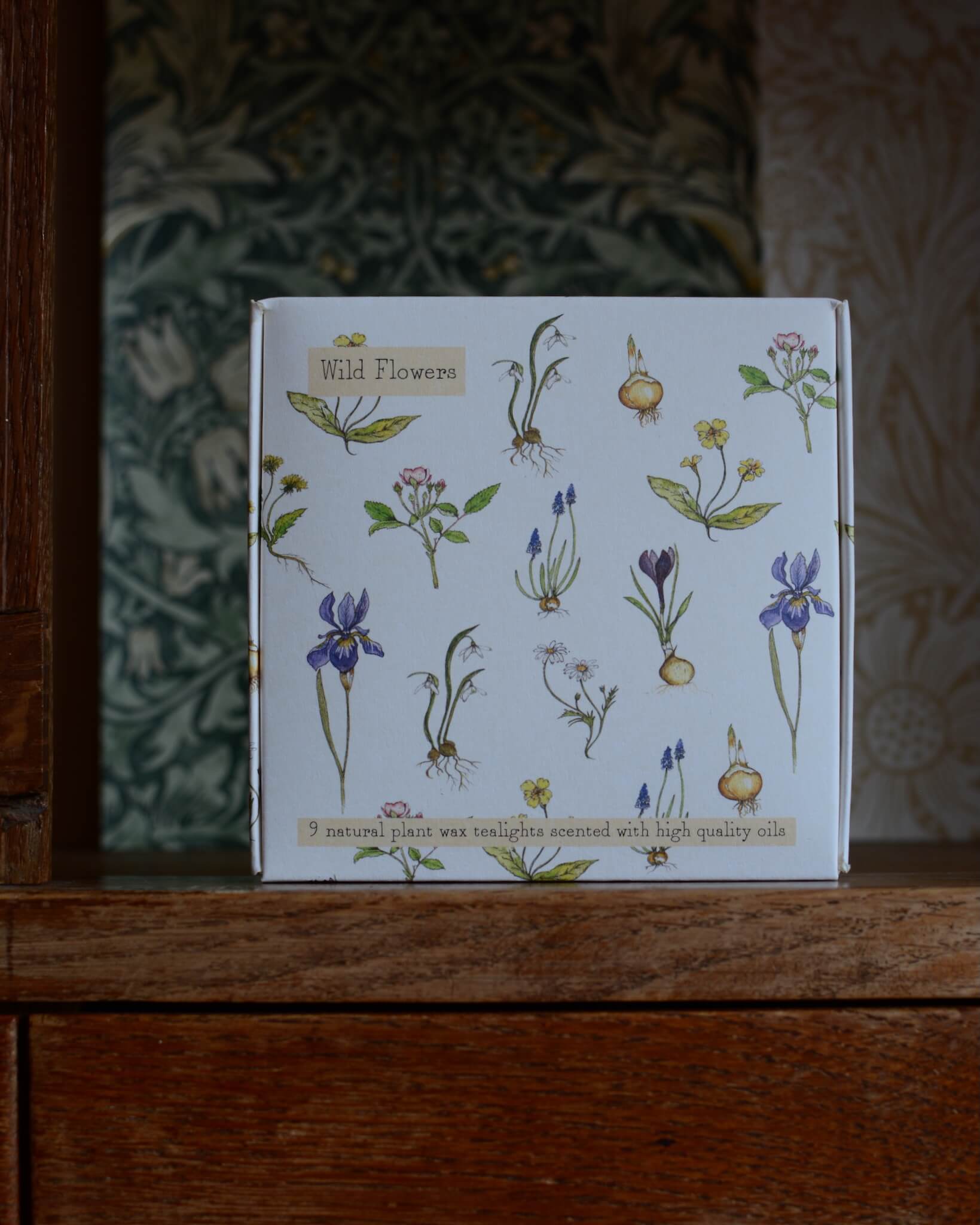 A box of tealights with an illustration of wild flowers on the box.