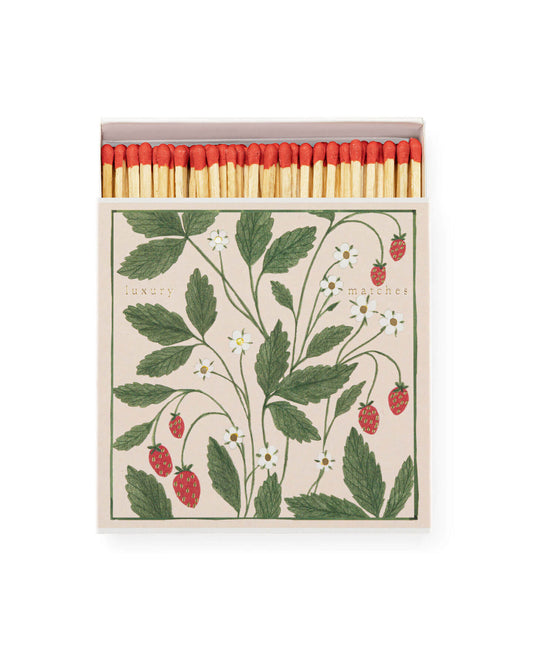 A square box of matches featuring an illustration of wild strawberries.