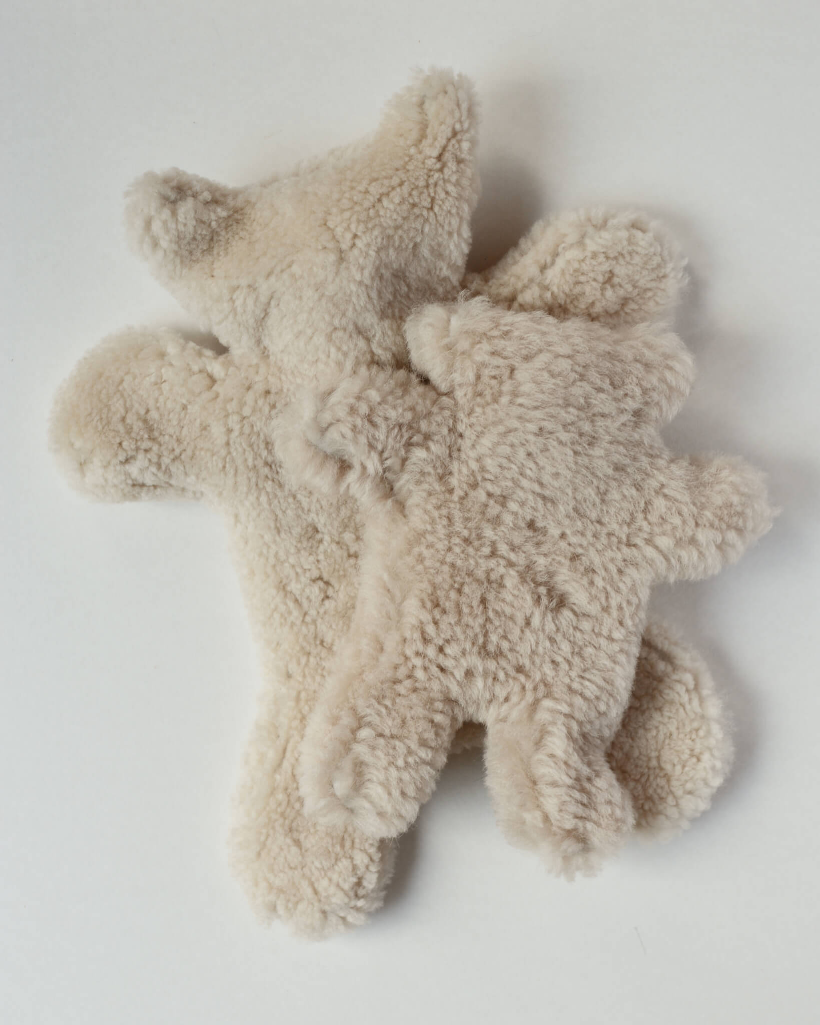 Teddy bear sheepskin hot water bottles on a white background.