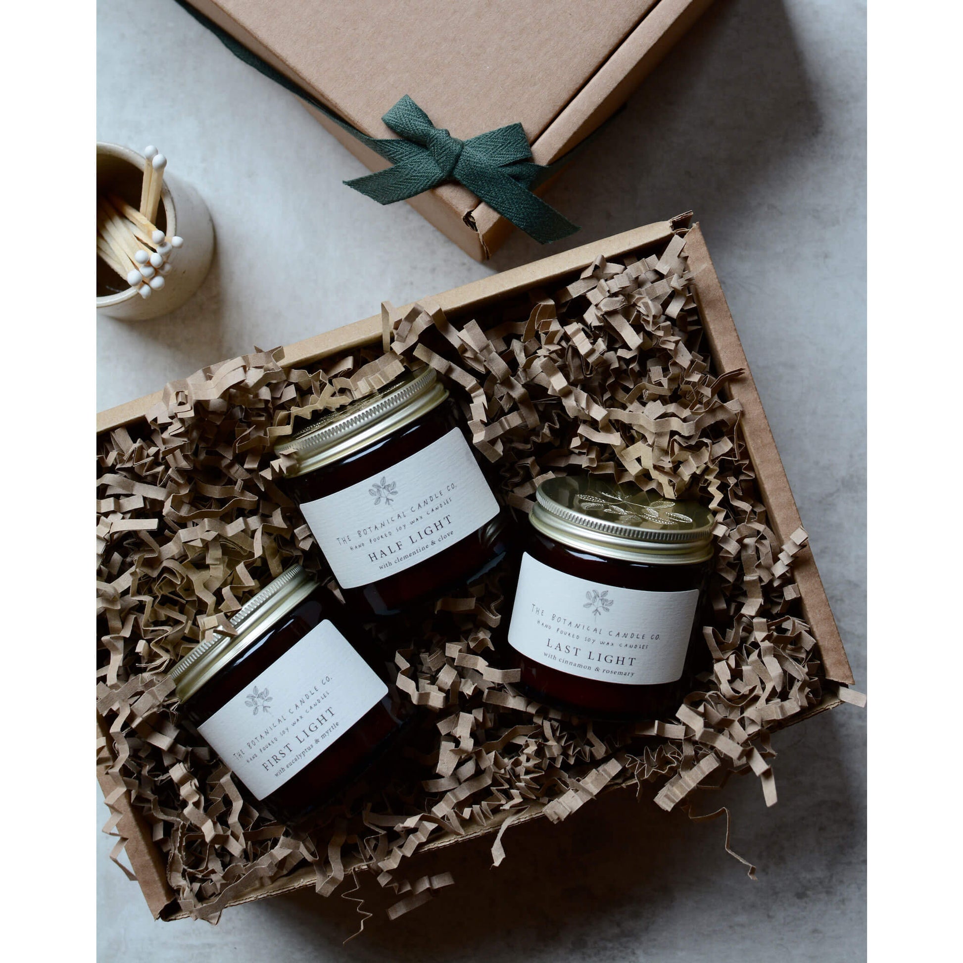 Winter Light Candles in amber jars, within a gift box.