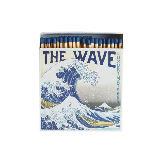 Match box depicting a Japanese illustration of a wave, on a white background.