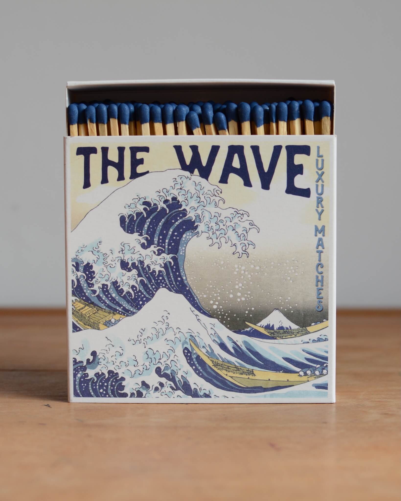 A box of matches with a blue-tone Japanese illustration of a wave.