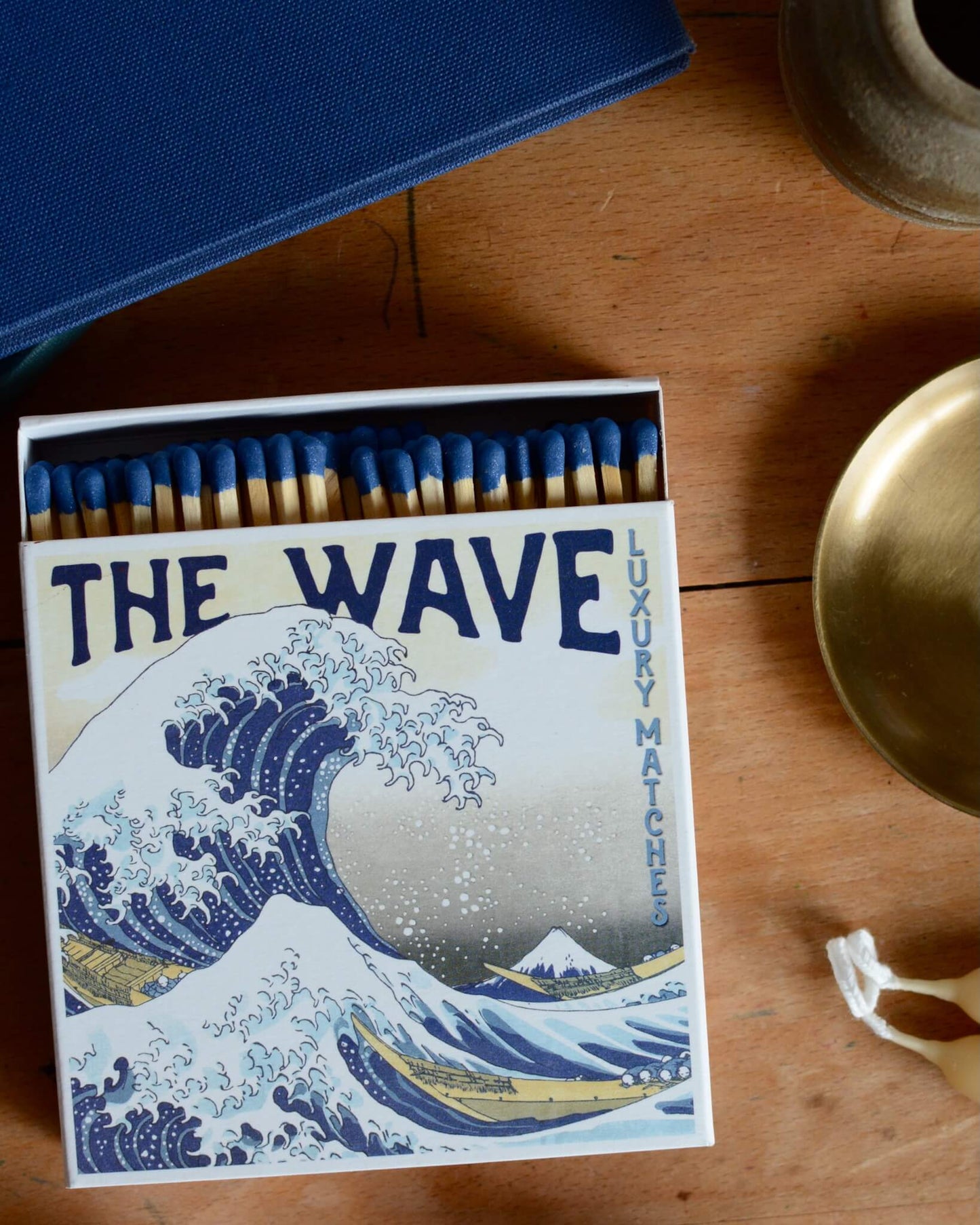 A box of matches with a blue-tone Japanese illustration of a wave.