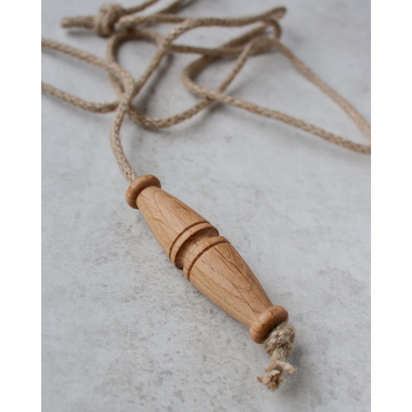 Oak toggle-style light pull with jute rope.