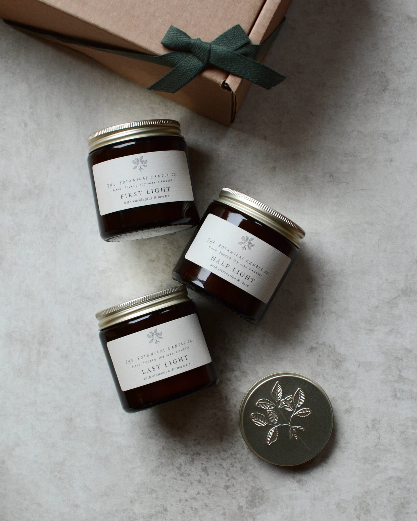 A trio of winter blend candles in amber glass jars.