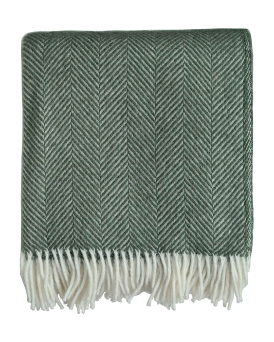 A green woollen herringbone blanket, on a white background.